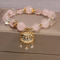 Women's yellow agate crystal bracelet on adjustable gold silk cord.
