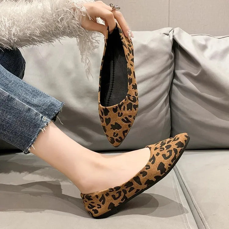 Women's leopard print flat pumps with pointed toe and low heel on a cotton cloth upper.