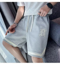 Men's loose straight wide leg sports shorts with low waist drawstring in polyester, fifth pants length