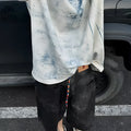 Korean style loose fit tie-dye printed t-shirt on a solid colour background.