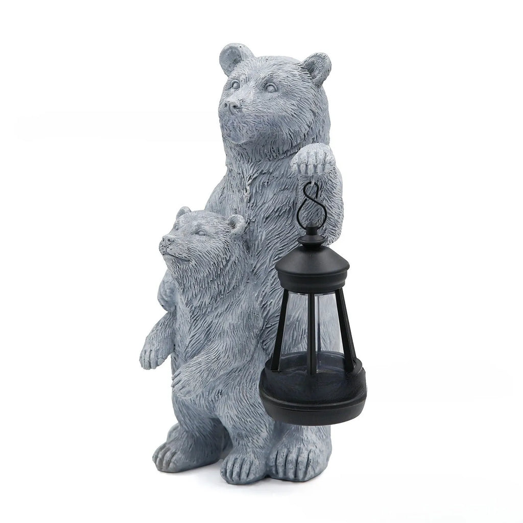 Resin black bear mother and child lantern ornament on a wooden shelf with soft glow