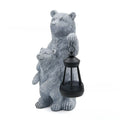 Resin black bear mother and child lantern ornament on a wooden shelf with soft glow