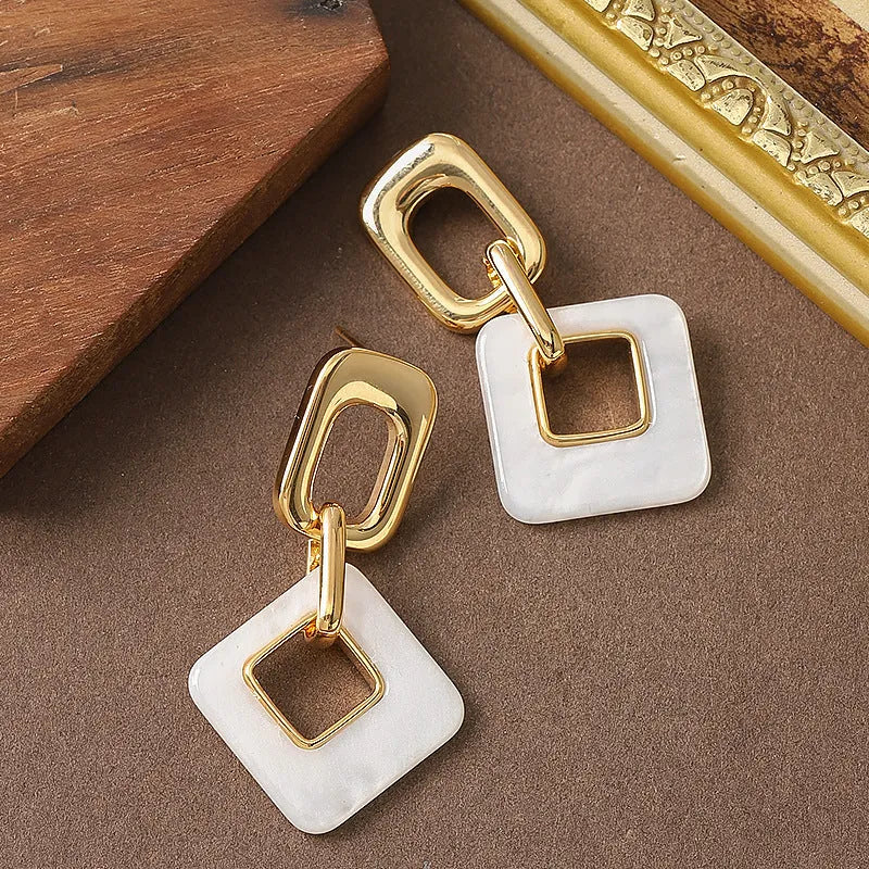 Copper geometric square earrings with hollow design and chamfered corners in metallic finish