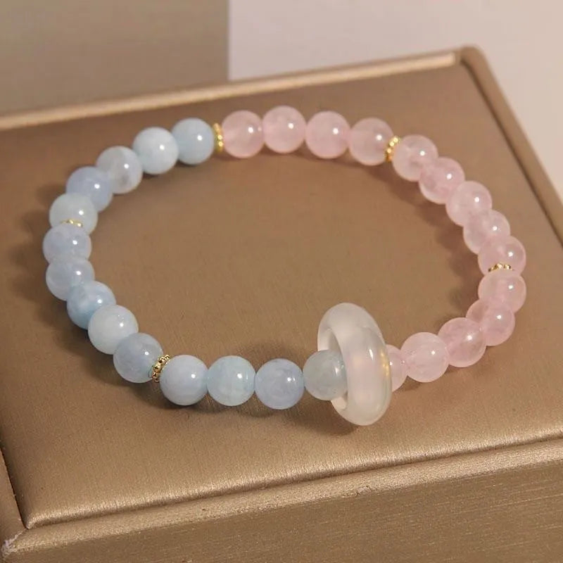 Women's aquamarine crystal bracelet set with pink beads and mixed materials in dopamine colours