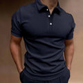 Man wearing a grey loose-fit button-front short sleeve t-shirt for casual leisure.