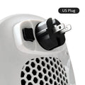 White ceramic electric heater with remote control on a table, showing air vent and control panel.