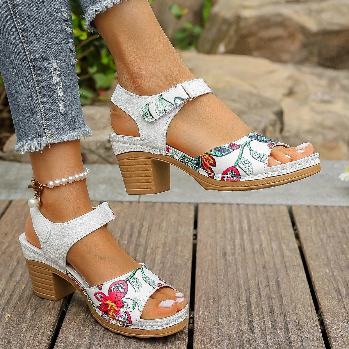 White women's high heel sandals with an adjustable velcro strap buckle fastening.