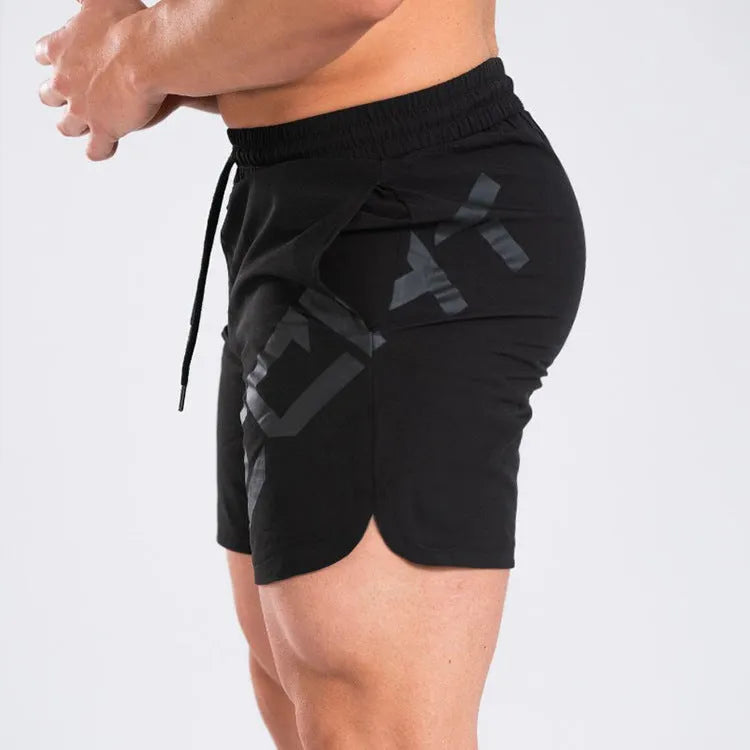 Men's black elastic quick-dry running shorts with mid waist and knee-length leg.