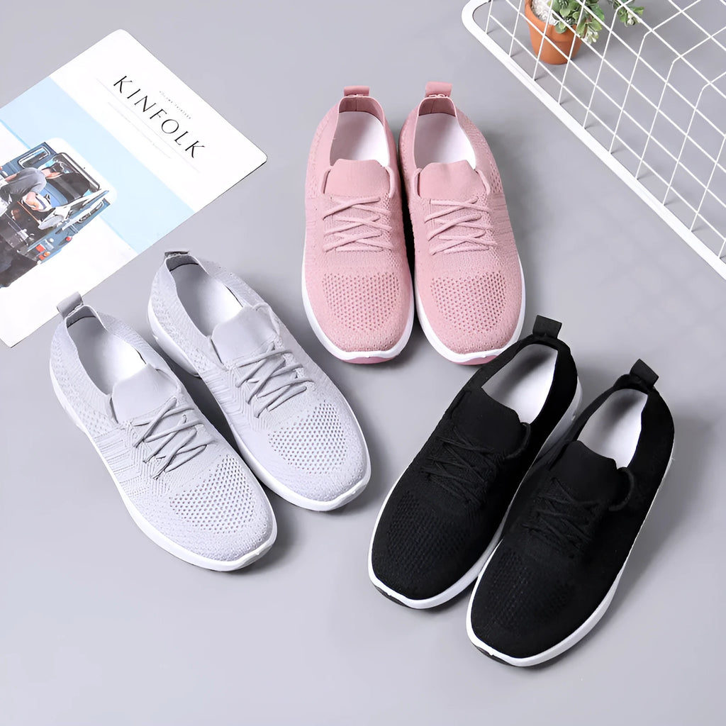 Women's solid colour mesh sneaker with round toe and white PVC sole on a grey background