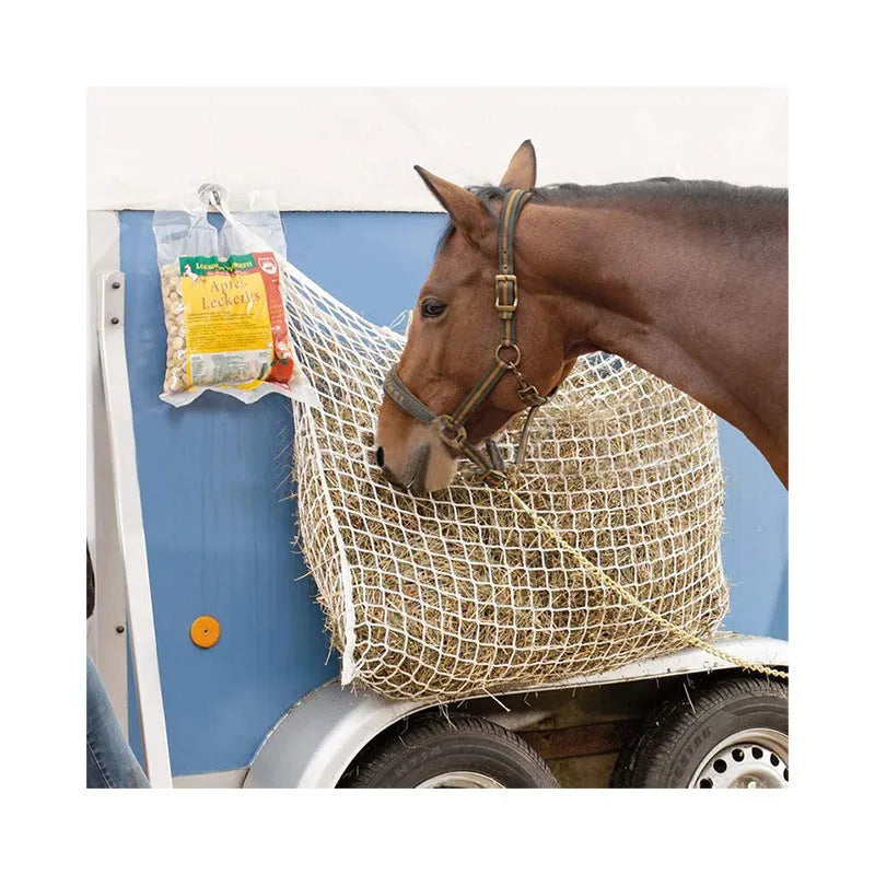 Woven grid horse feeding bag hanging with hay, shown in black colour