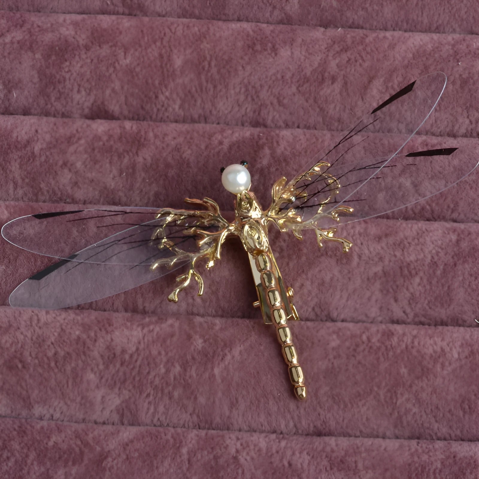 Golden dragonfly-shaped women's hair clip made from alloy with a side fastening.