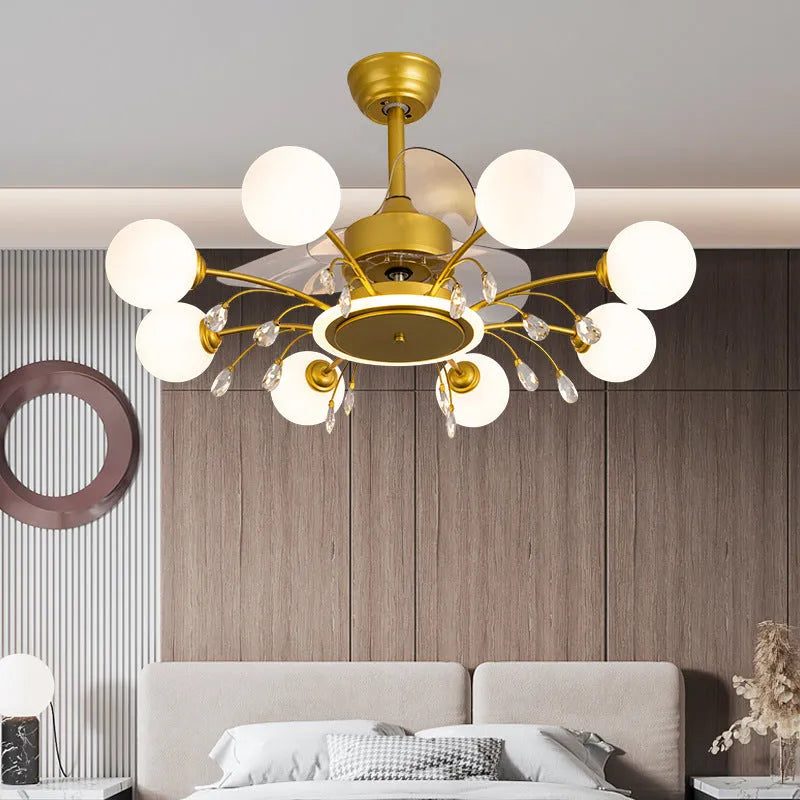 Black and gold ceiling fan light fixture with acrylic shade and metal blades, shown with remote control