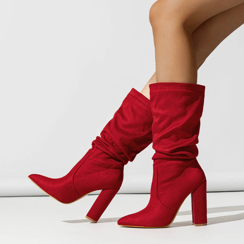 Women's black suede chunky heel boots with pointed toe and middle calf length.