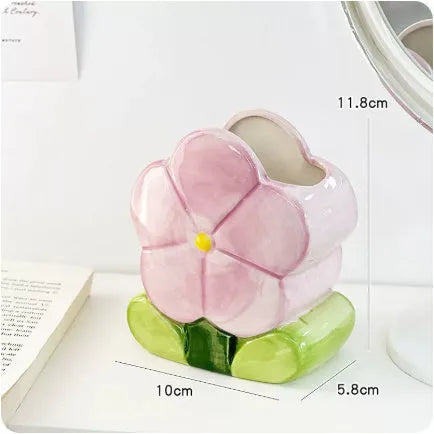 Ceramic desktop pen holder box with floral design in blue, pink, or purple.