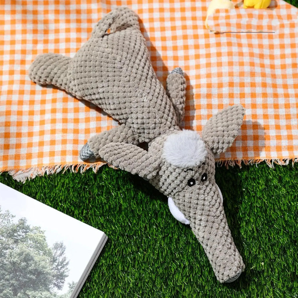 Plush animal-shaped dog toy with a bumpy corn kernel texture, shown in grey, green, and yellow colours.