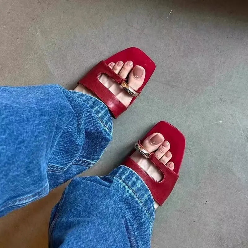 Leather upper outdoor slipper with square scaffolding toe and rubber sole in black, red, silver, and white.