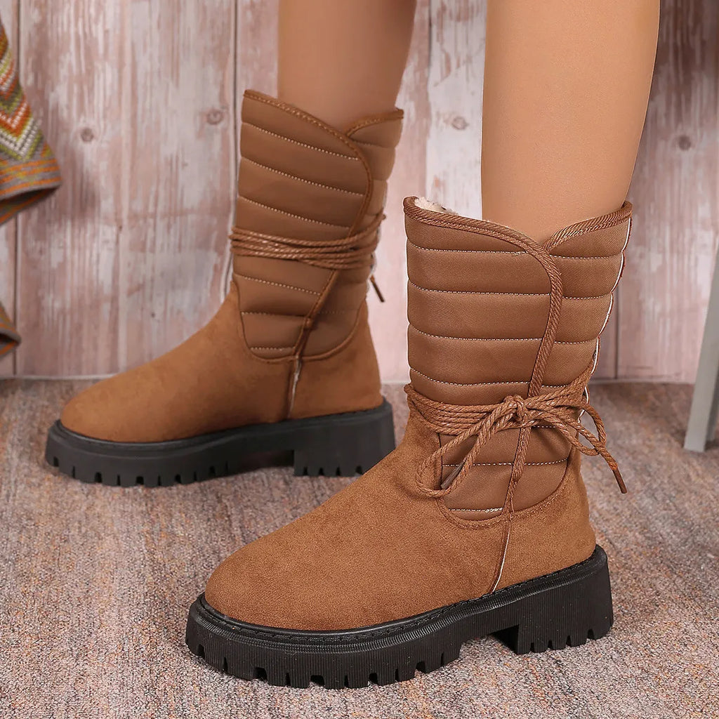 Women's black suede chunky heel snow boots with fleece lining and lace-up design.