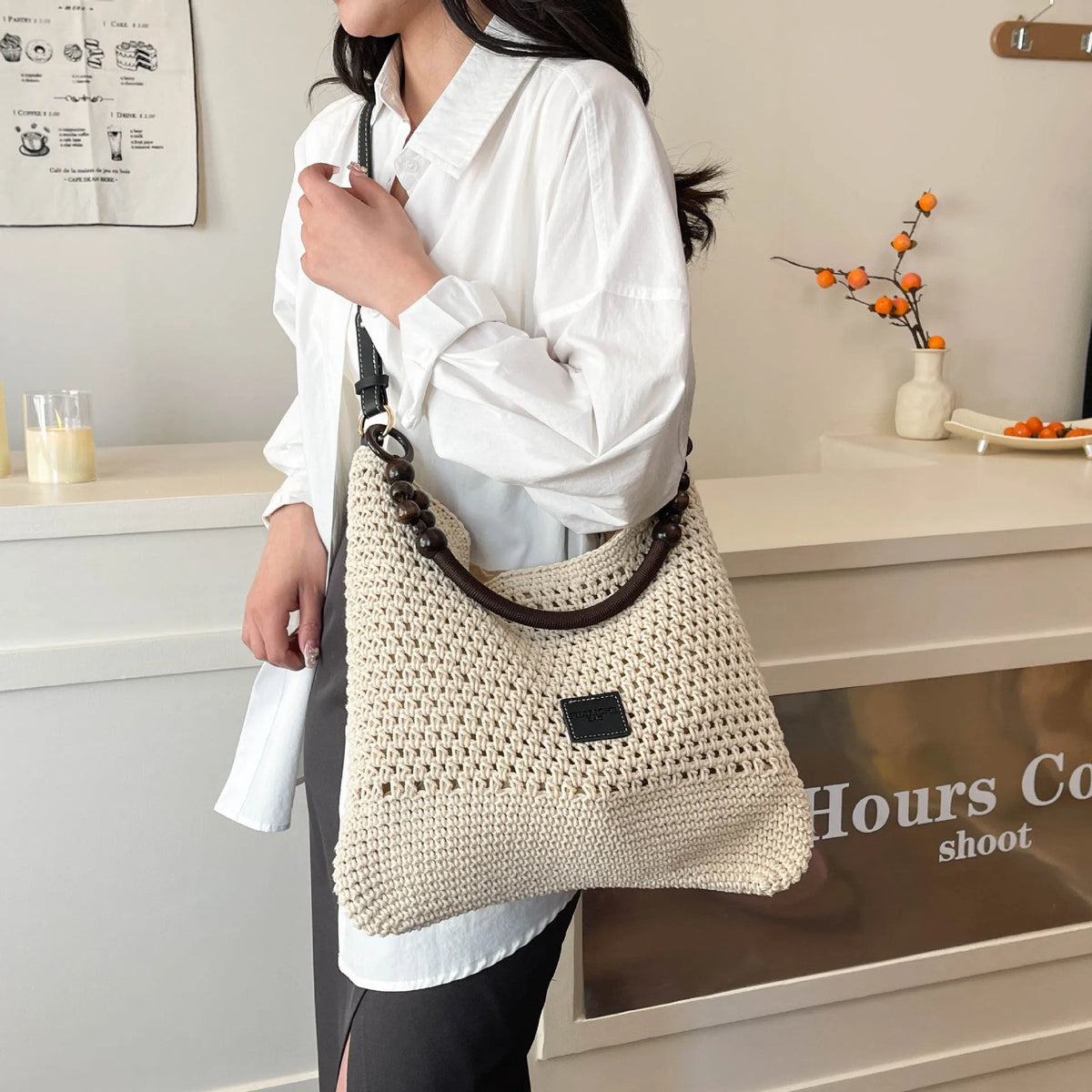 Knitted tote beach bag showing bucket shape, contrast stitching, and crossbody strap