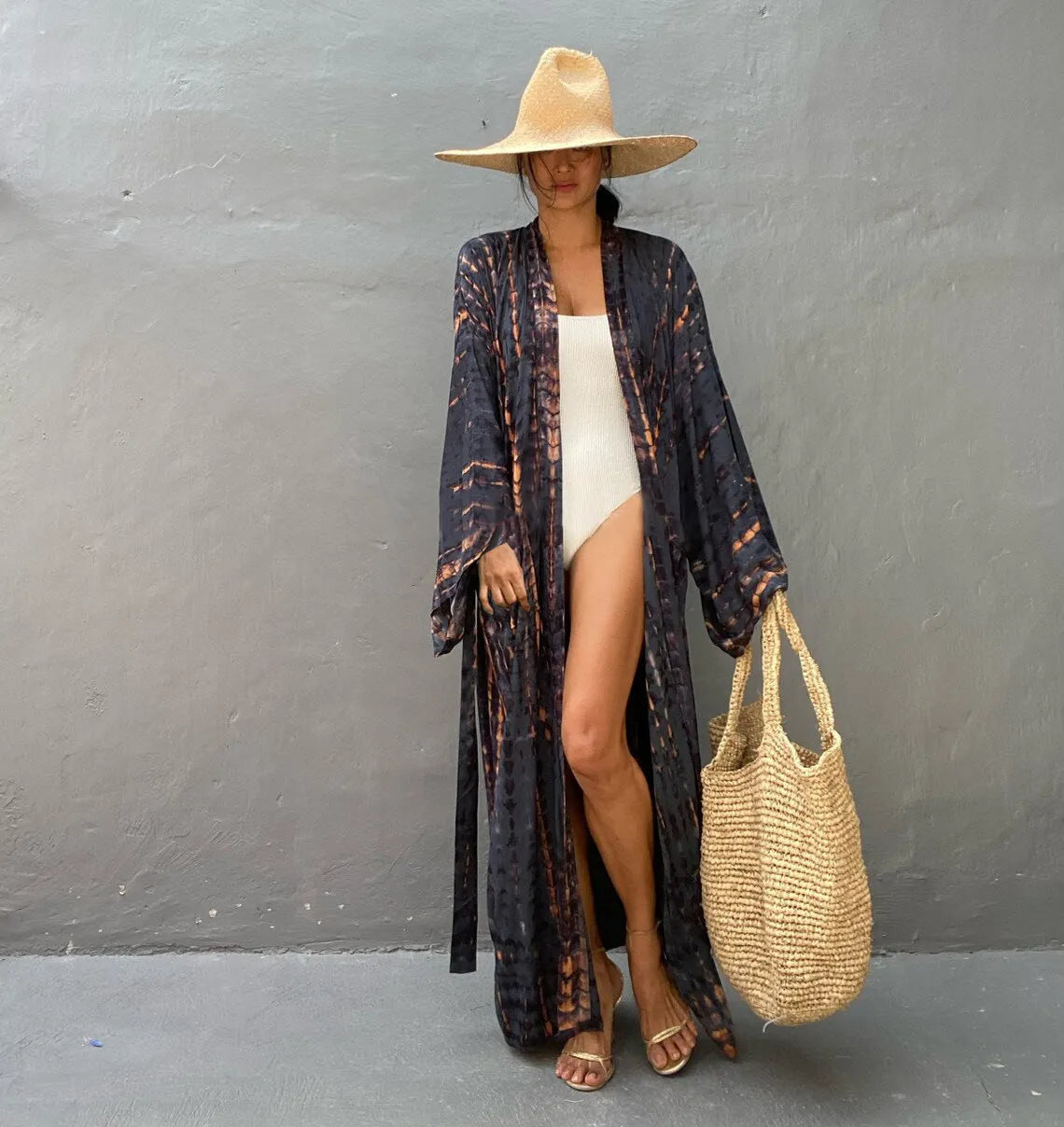 A printed, loose-fitting cotton beach cover-up blouse on a hanger, shown in a rust red colour from the DN0712 series.
