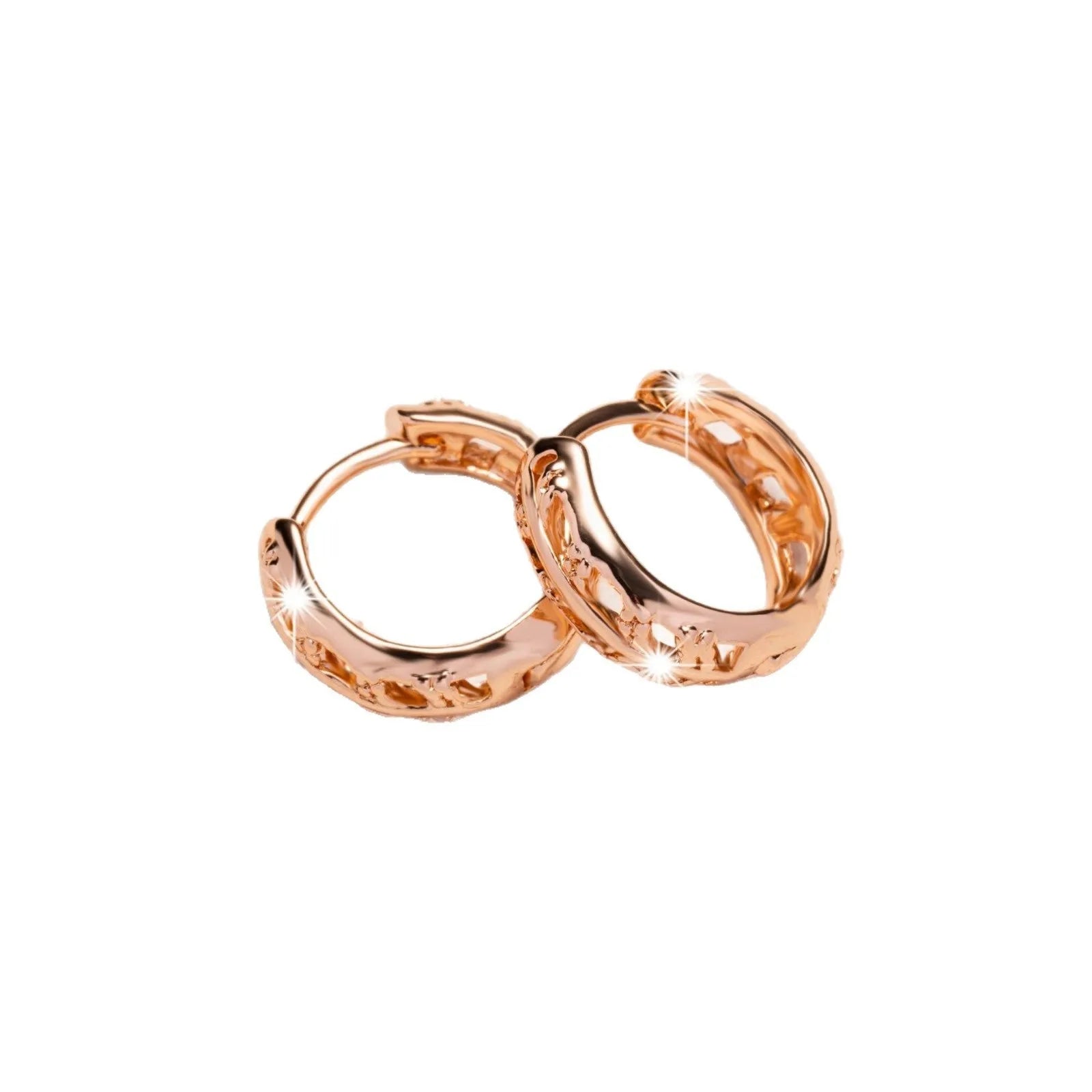 Rose gold coloured hollowed out copper earrings featuring a leaf and heart shape design.