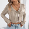 Women's khaki short coat with lace-up front and hollow-out design, long sleeves, casual style.