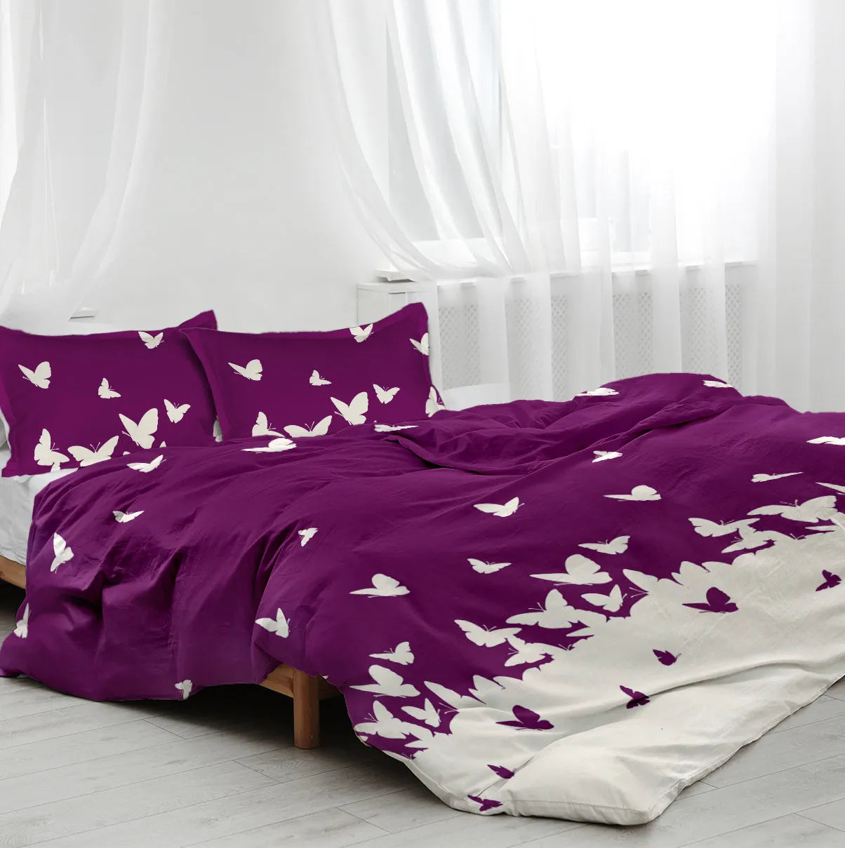 Purple butterfly reversible microfiber comforter set with two pillow shams on bed