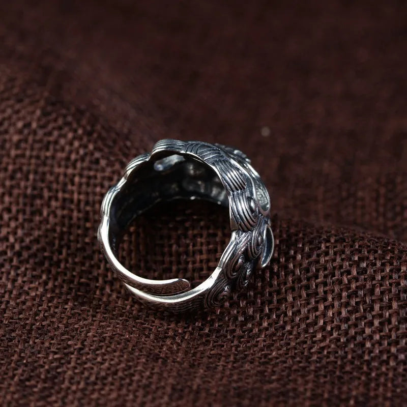 Sterling silver open ring with a detailed domineering jibeast animal and zodiac pattern.
