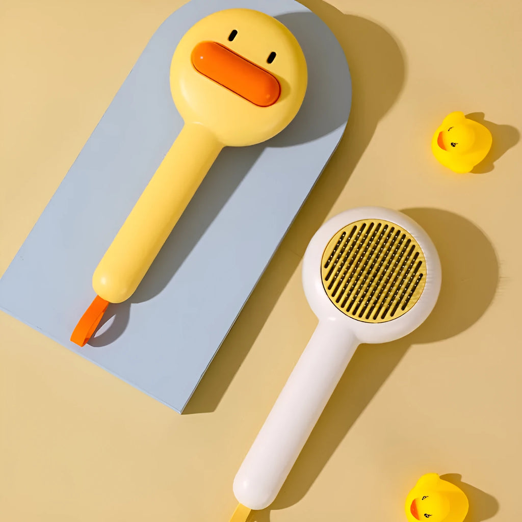 Yellow plastic pet grooming comb with open-section needle teeth for removing hair from cats and dogs.