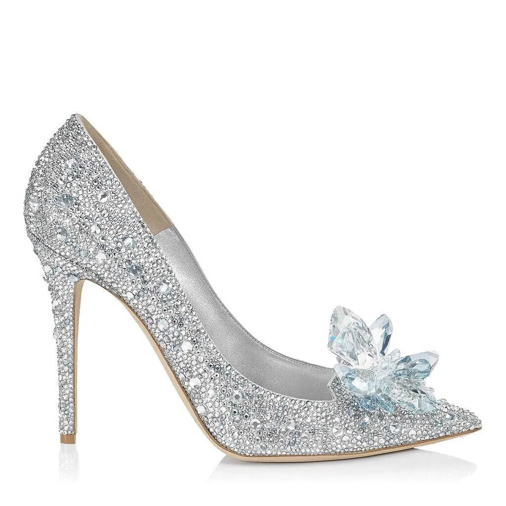 Gold women's pointed toe high heels with rhinestone and bow decoration on a stiletto heel.