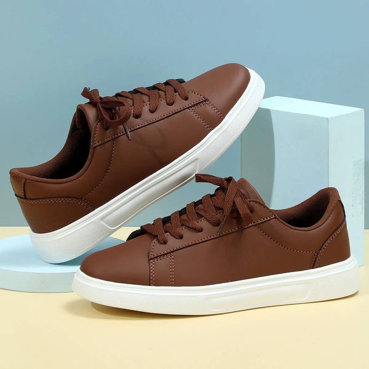 Beige brown platform casual skateboard sneaker with round toe and cross-strap detail on a white background.