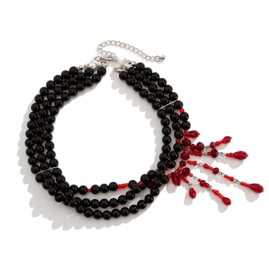 Men's blood drop tassel necklace with geometric crystal pendant and imitation pearls on a chain.