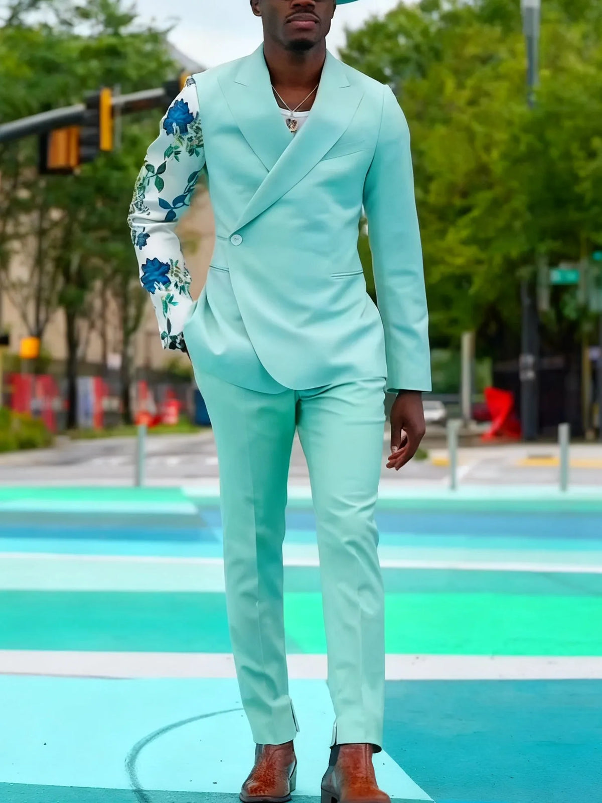 Mint green double-breasted suit set with floral print sleeve and ankle-length trousers.
