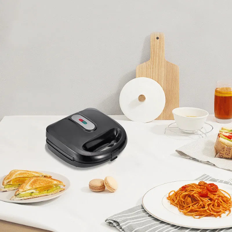 Black double-sided electric sandwich pan with stainless steel lid and six non-stick pans.
