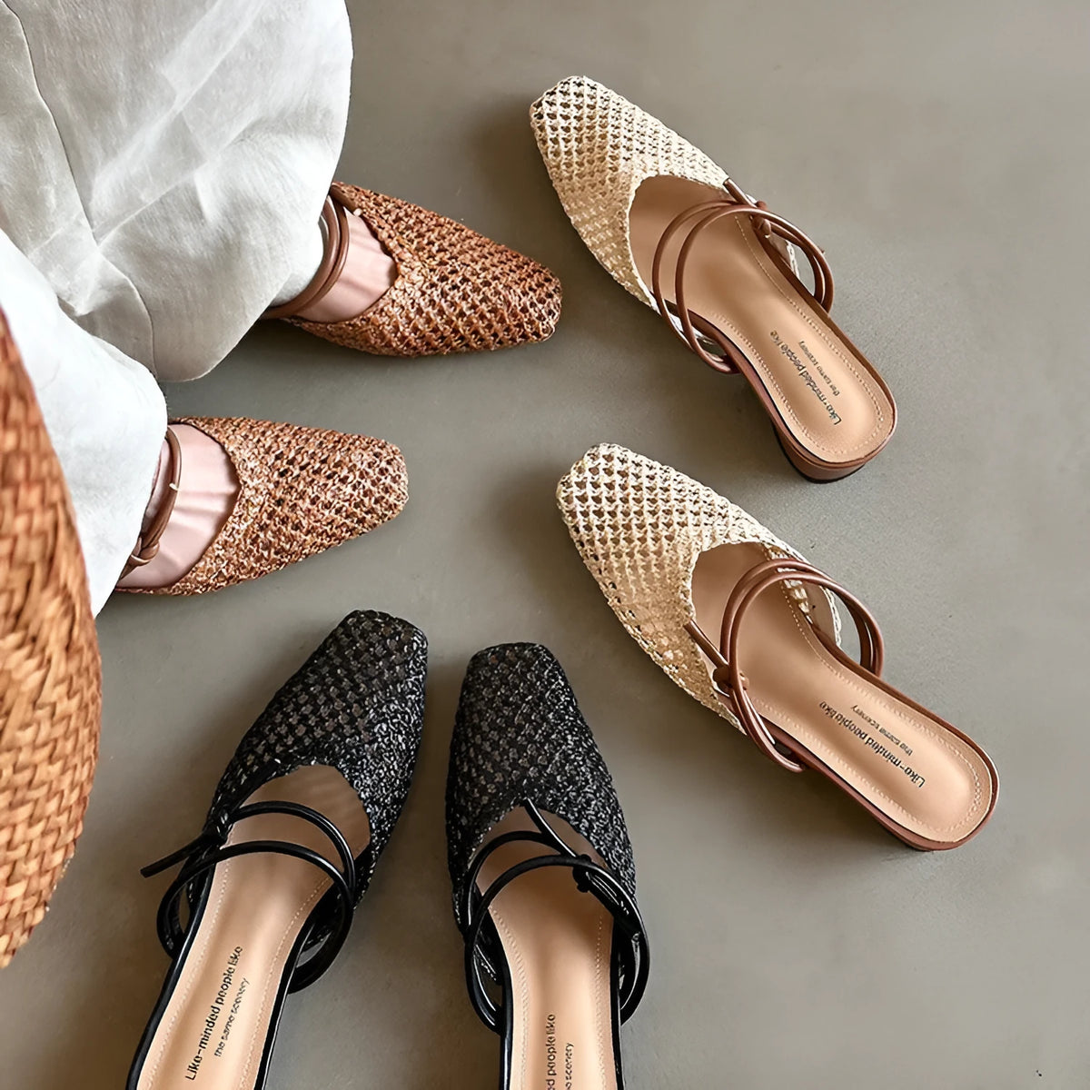 Women's black square toe slippers with hollow-out design and a chunky heel on a rubber sole.