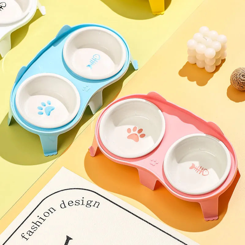 Blue ceramic cat food and water bowl set on a white elevated stand with a storage hook.