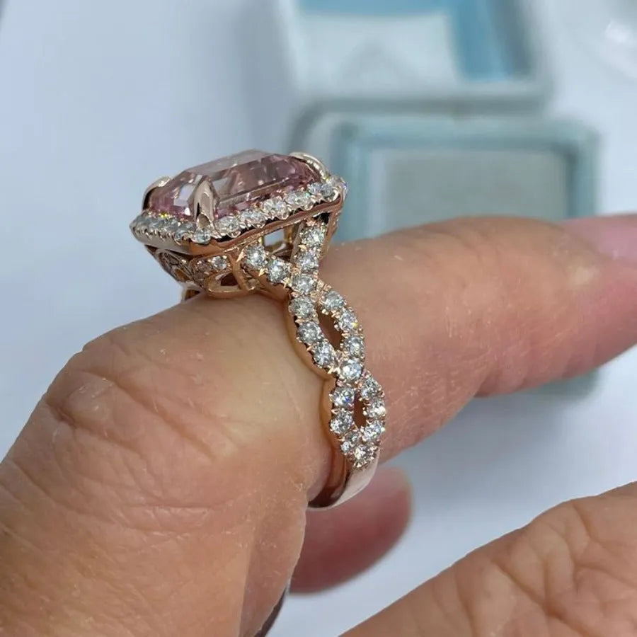 Geometric rose gold alloy ring on a plain background showing its shape and electroplated finish.