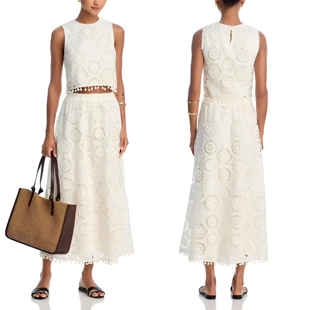 White women's retro style suit set with sleeveless top and embroidered long skirt.
