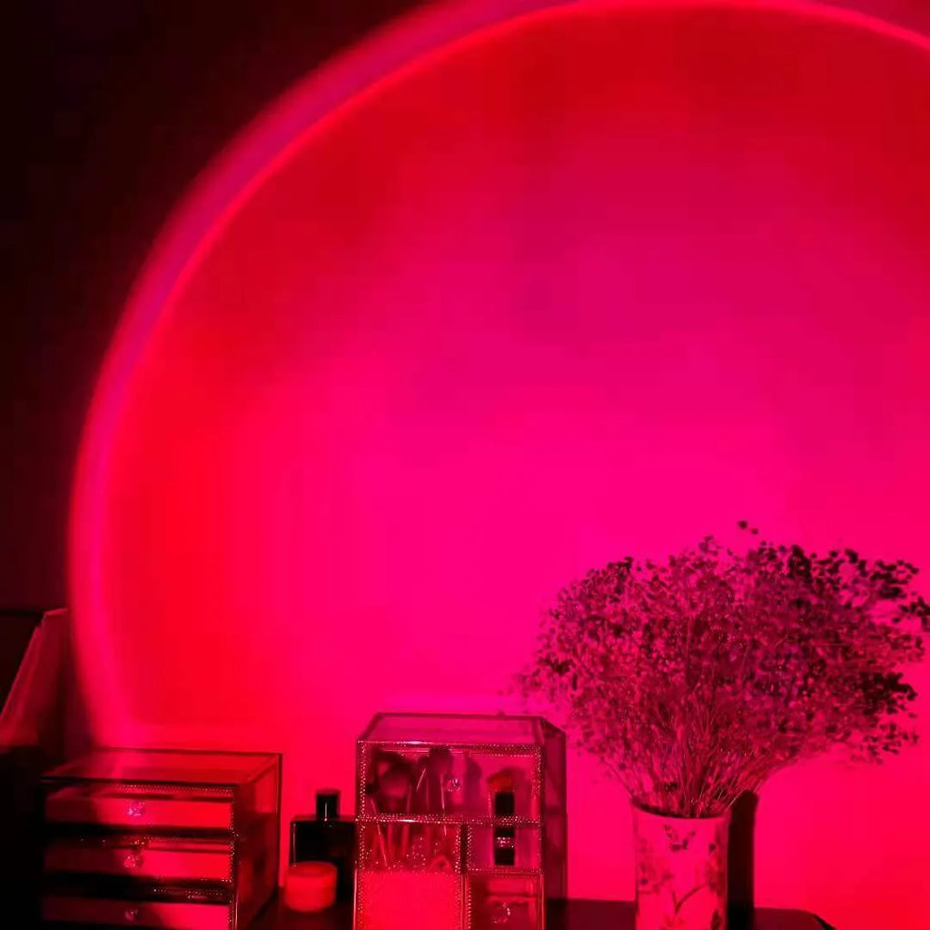 Rechargeable sunset red rainbow projection lamp with USB cable on tabletop