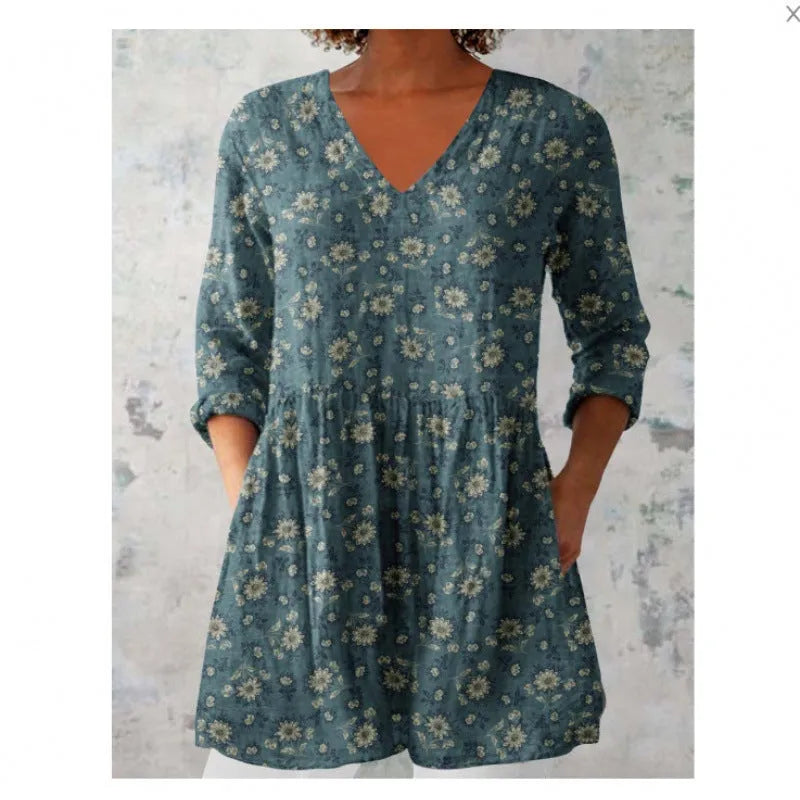 Women's printed loose-fitting dress with wide waist and three-quarter length sleeves.