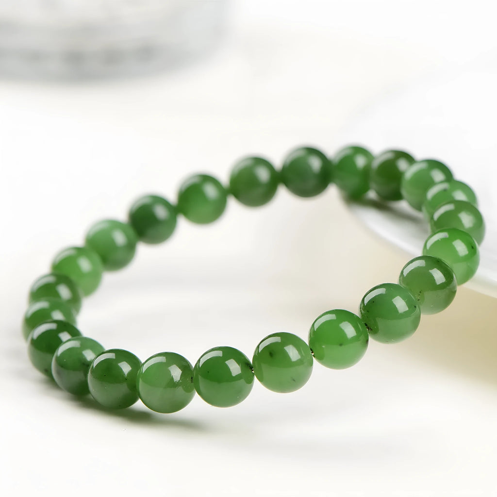 Natural Hetian jade jasper ball bracelet with polished beads on a wrist.