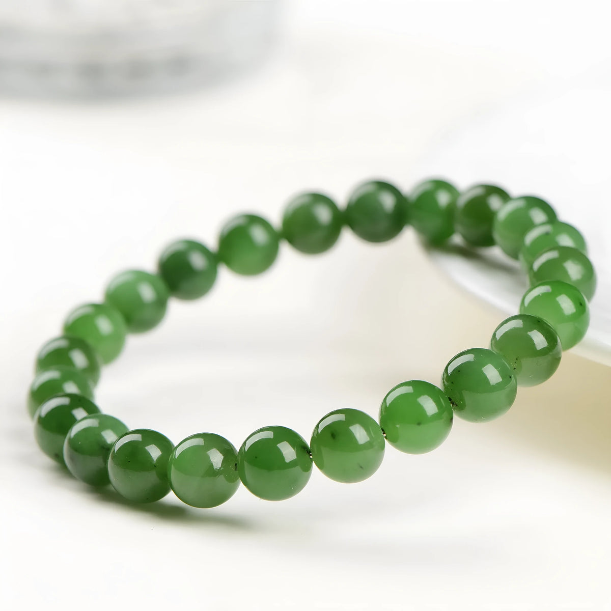 Natural Hetian jade jasper ball bracelet with polished beads on a wrist.