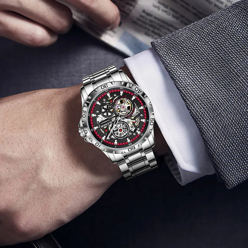 Silver men's automatic watch with hollow-out dial showing mechanics, luminous markers, and a blue stainless steel strap.