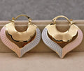 Gold electroplated copper heart-shaped hollow stud earrings with lace-inspired openwork design and geometric round elements