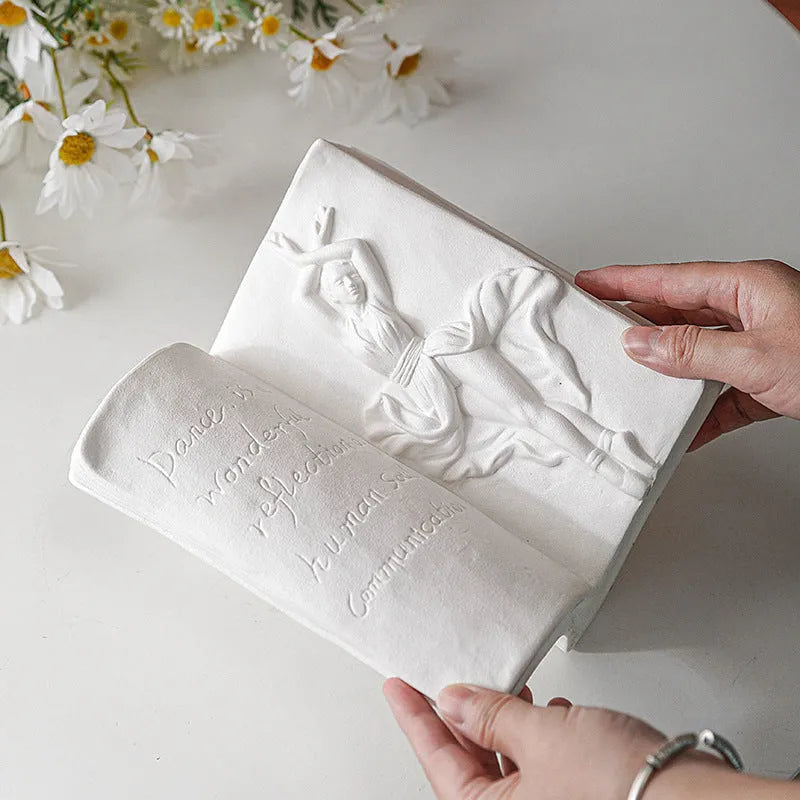 Ceramic book stand with glazed surface in one of four artistic designs: lover, dancer, beauty and beast, or brushed face