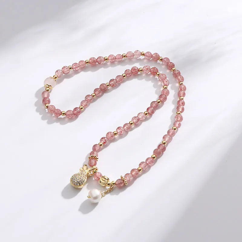 Strawberry quartz crystal bracelet with geometric pink beads on adjustable string