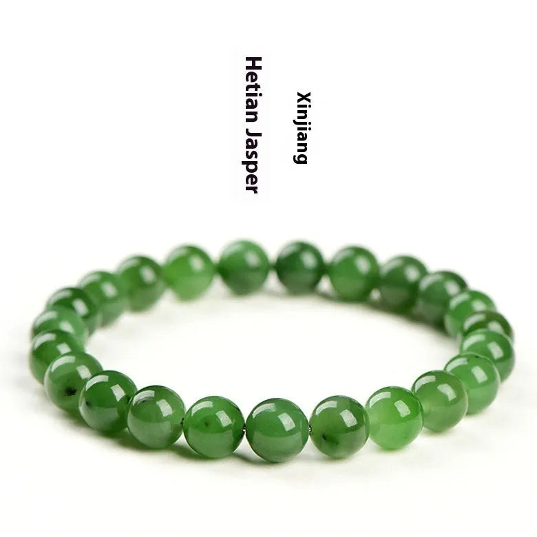 Natural Hetian jade jasper ball bracelet with polished beads on a wrist.
