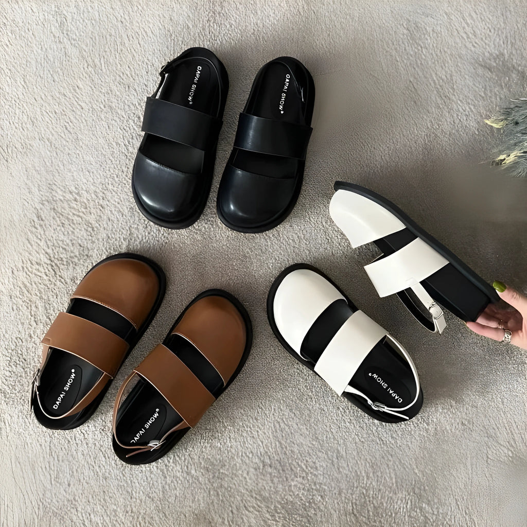 Retro closed-toe sandals with an adjustable ankle strap buckle in black, brown, or apricot colour.