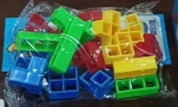 Plastic balance stacking game with 16 coloured blocks, chassis, and base on a table.