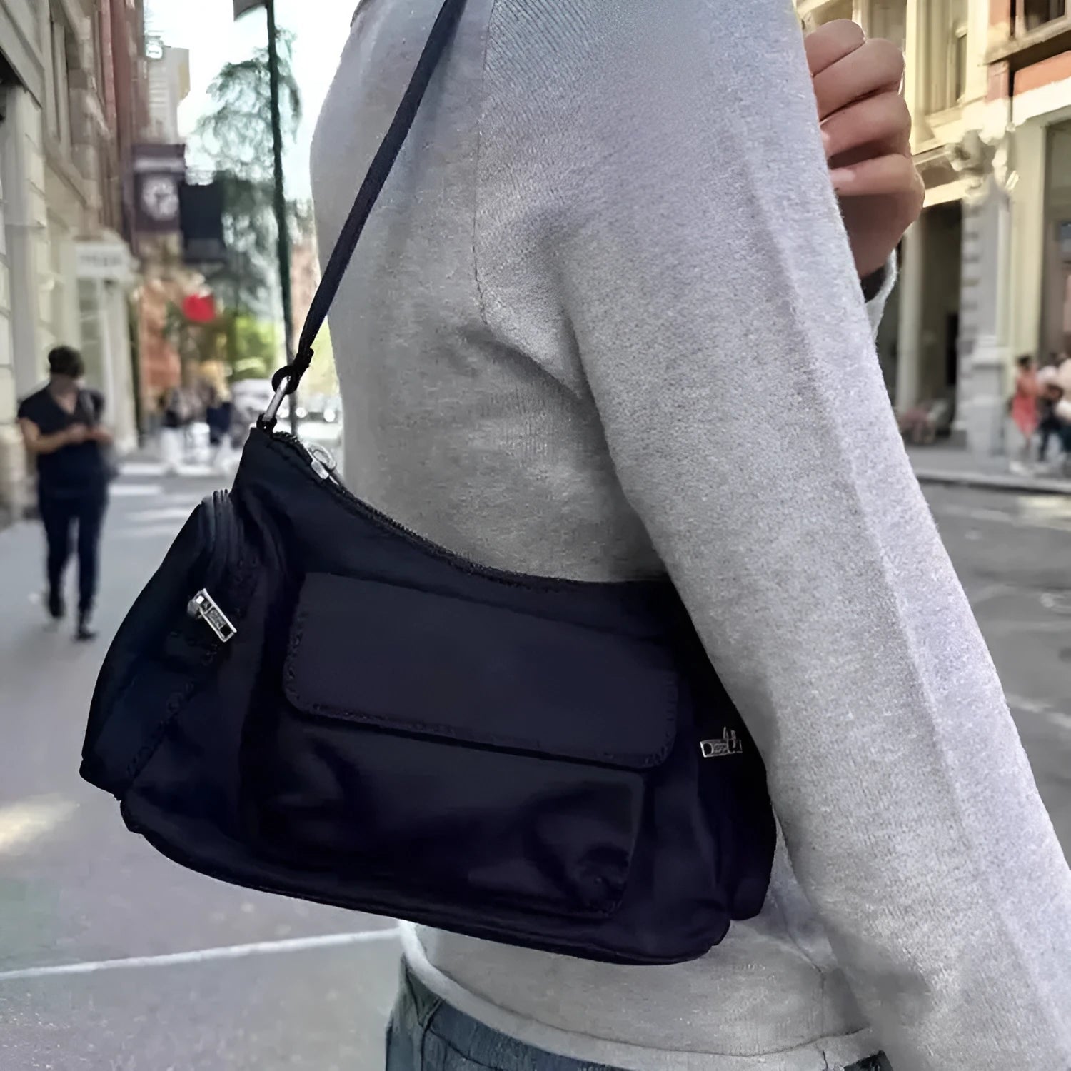 Black nylon lightweight double pocket women's shoulder bag showing side line detail