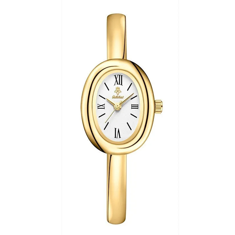 Women's gold and silver oval retro quartz watch with spiral pattern dial options on wrist.